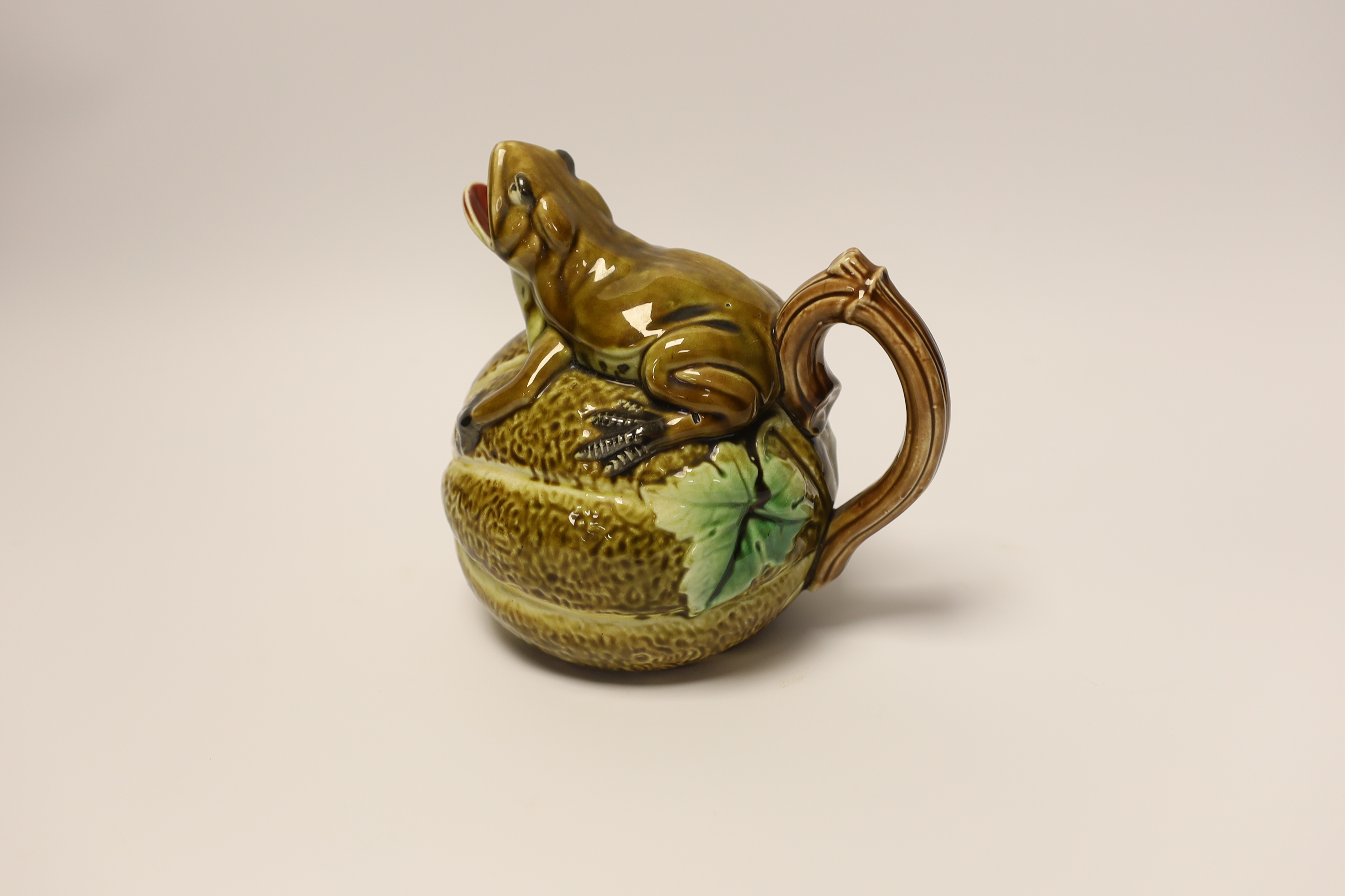 A majolica jug in the form of a frog, sitting on a melon, 17cm high